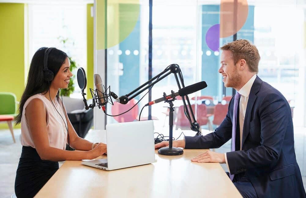 Person recording a podcast in a professional studio environment.