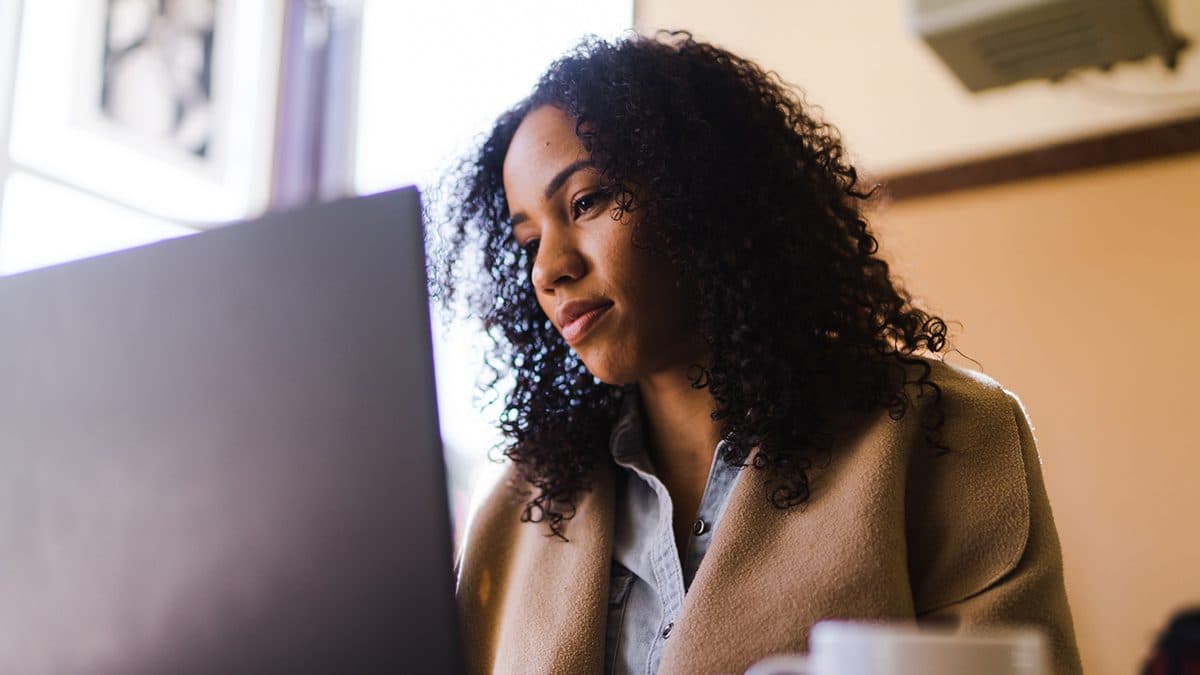 a woman looking at a laptop screen