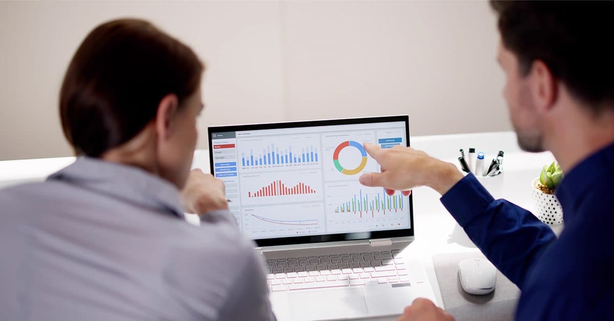 two people viewing web analytics on a laptop screen