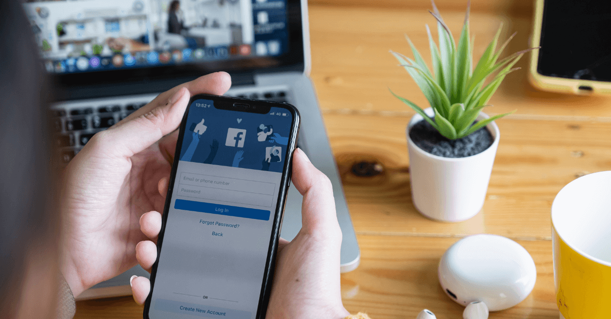 a person logging into facebook on their mobile device