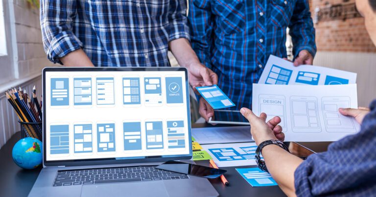 graphics representing the UX design process on a laptop screen