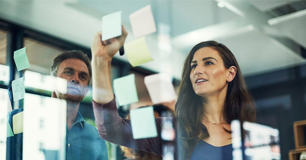 a person brainstorming an SEO friendly business name with sticky notes