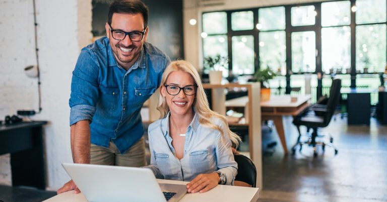 two small business owners looking at a computer