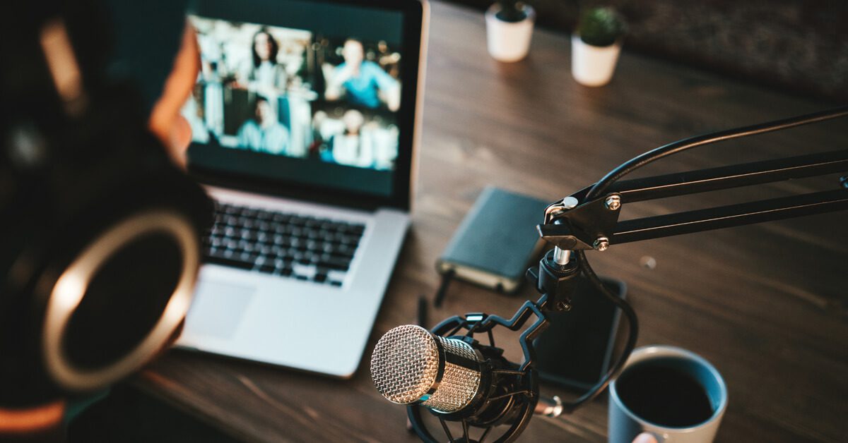 a person creating content with a microphone and laptop